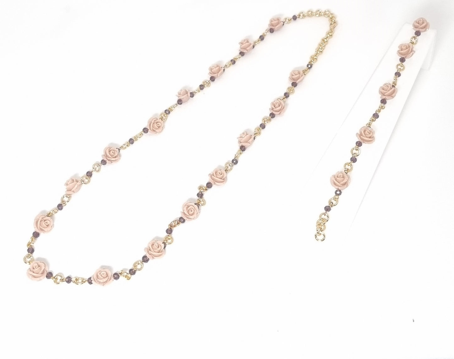 Collana LE ROSE .014 Un filo di maglie metallo dorato, piccoli cristalli violacei e piccole rose in resina color cipria.
