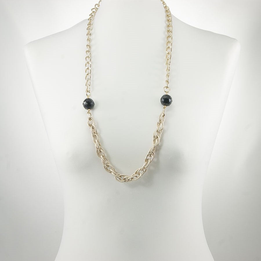Collana GRACE i metalli .011 un filo maglie metallo dorato e due grandi cristalli neri.