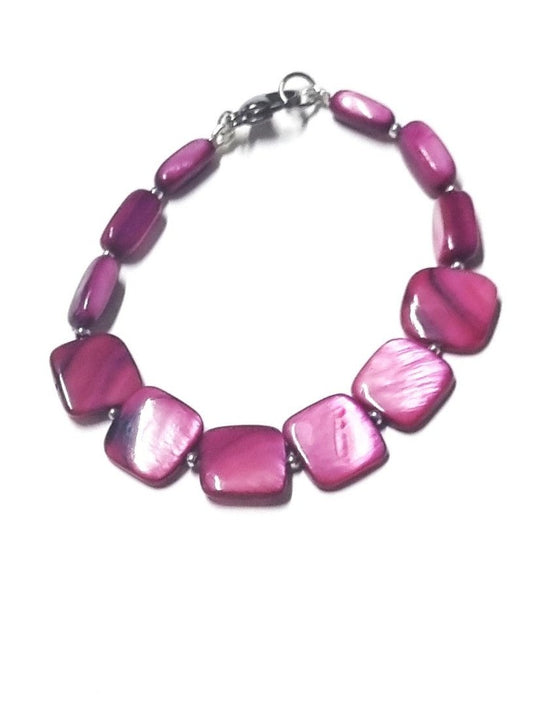 Bracciale LE PIETRE .044  piccoli dischi madreperla fucsia intervall.cristalli rosè centrale metallo e cristalli