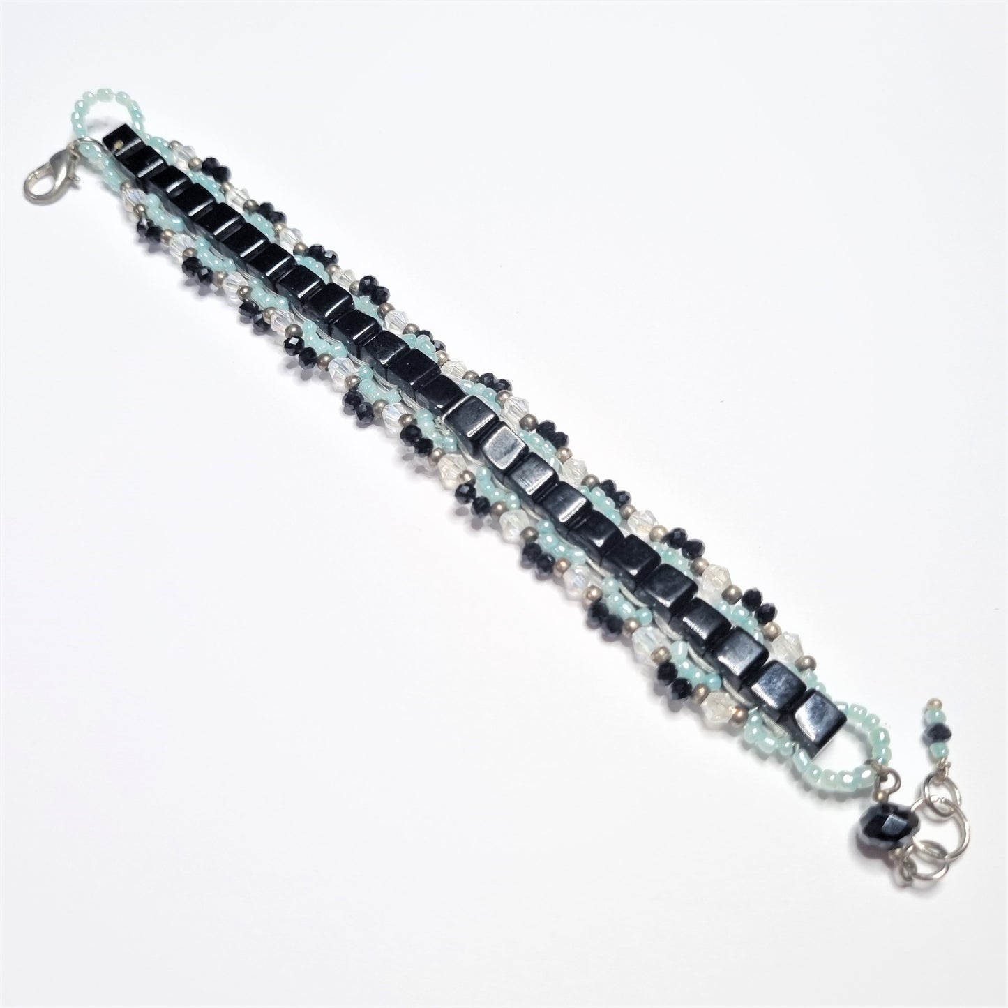 Bracciale ZELDA .026 quadrotti neri centrali, laterali cristalli azzurro,trasparente e nero.
