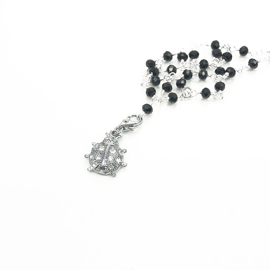Collana HERMIONE Le Ragazze .001, catenelle, piccoli cristalli neri e ciondolino metallo.