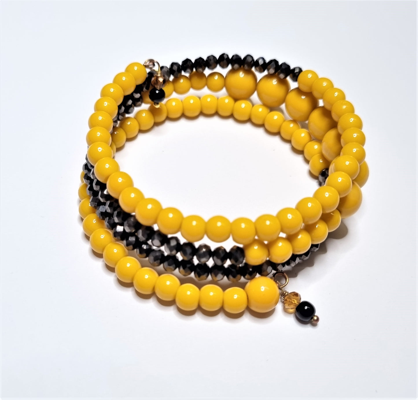 Bracciale LE PERLE .048  spirale di perle gialle e cristallo bronzo.